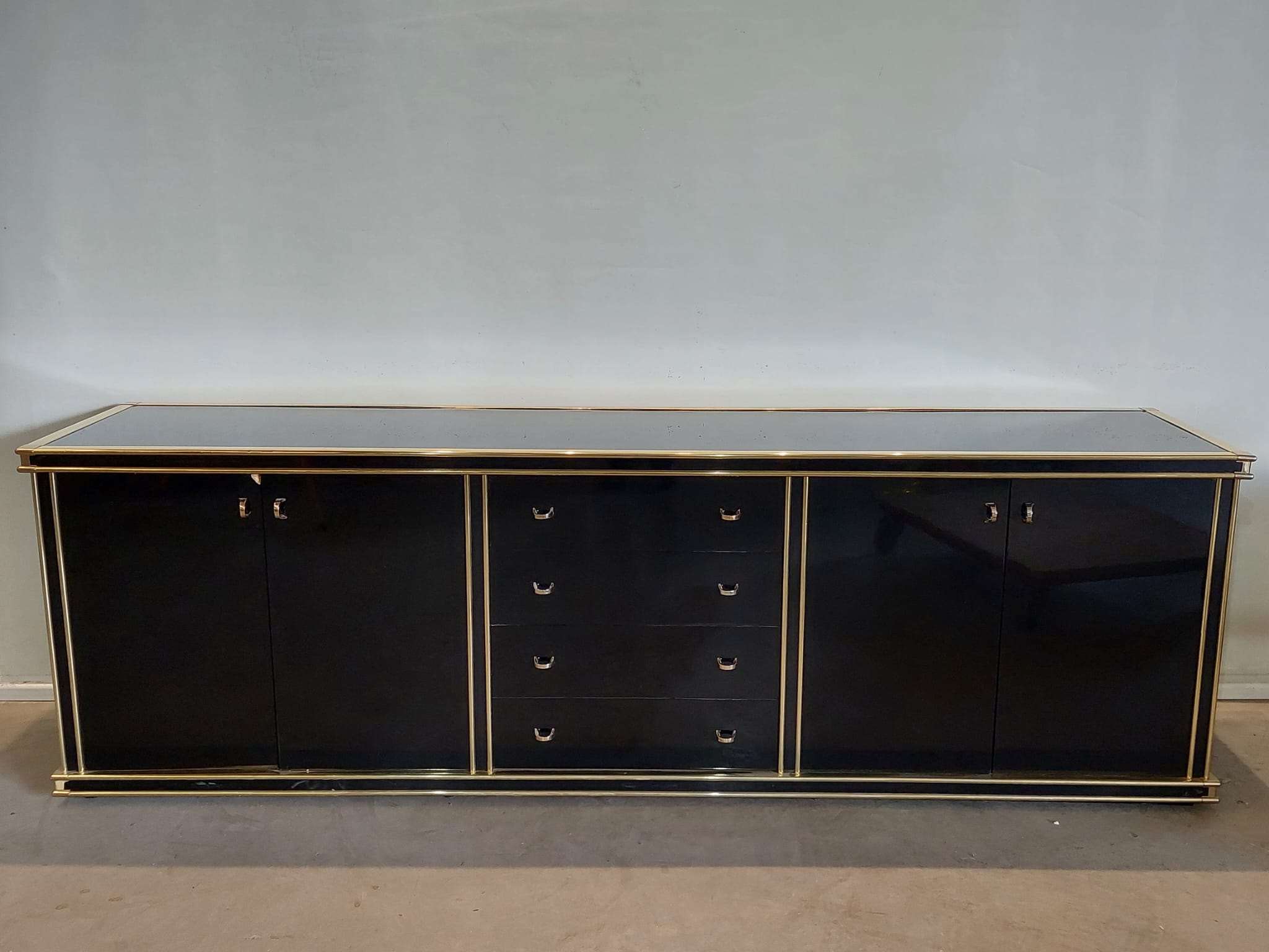 Black and gold lacquered sideboard. 426