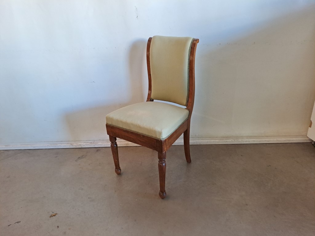 French Empire style dining chair. It features a design that evokes historic European styles of the 19th and early 20th century. The high-backed design and elegant lines are characteristic of styles such as French Empire, Biedermeier or neoclassical. Rental for events, advertising, series, films.