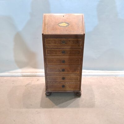 Bureau is a classic type of desk also known as a secretaire. It combines the functions of a desk and a chest of drawers or chest of drawers, ideal for spaces where both a work surface and storage are needed. Rental for events, advertising, series, films.