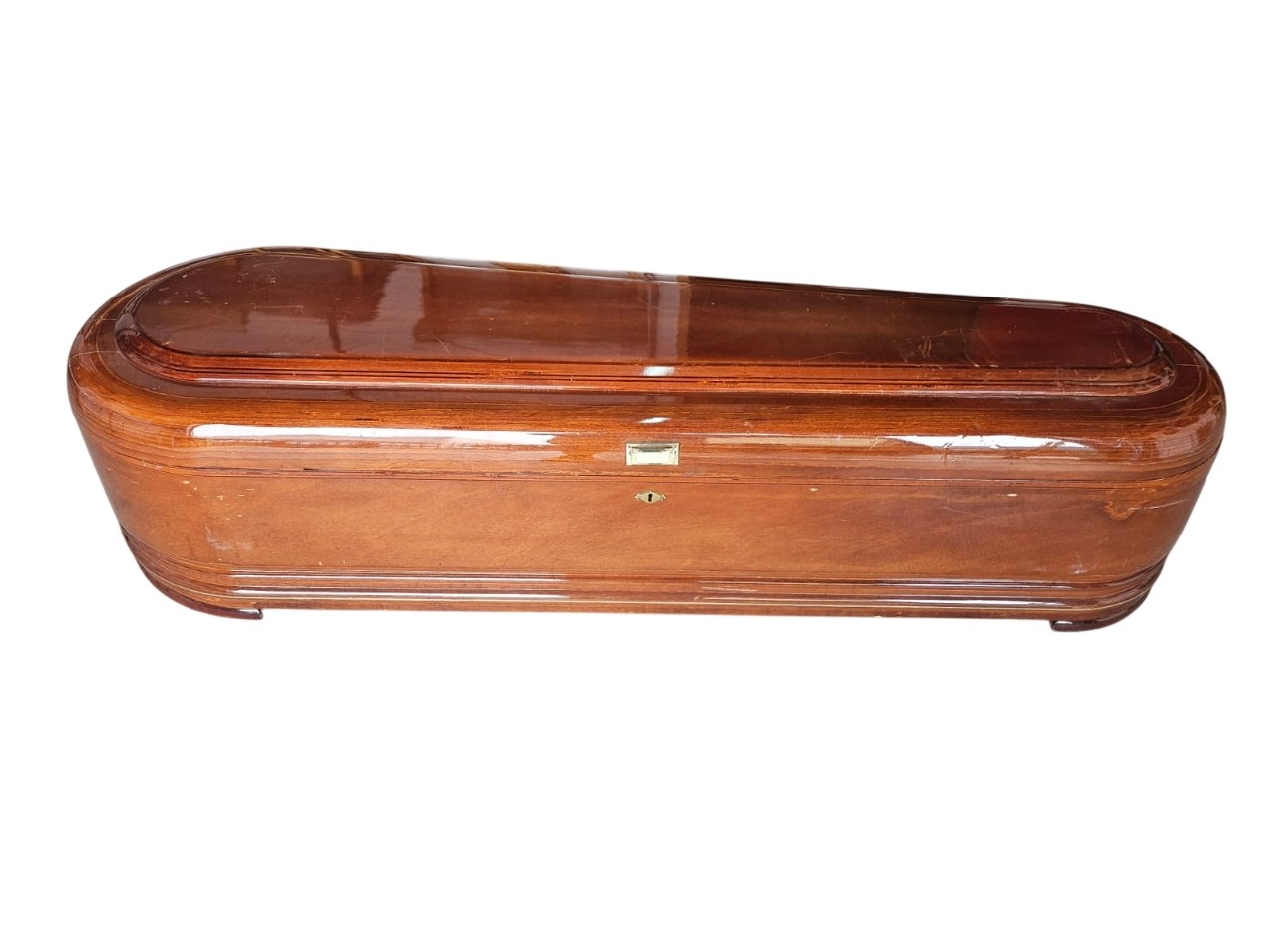 Wooden coffin coffin with a high gloss varnished finish, commonly known as a round or elliptical shaped coffin for hire for events, advertising, films and series.