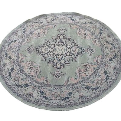 Round vintage or traditional style carpet with sage green and pink tones for rent for events, advertising, films and series.
