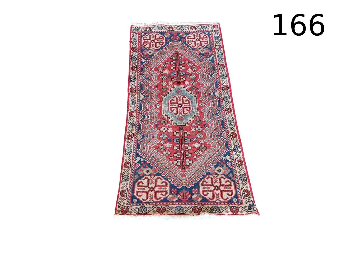Antique or vintage Persian tribal rug, handmade with wool and geometric design, for rent for events, advertising, film and series.