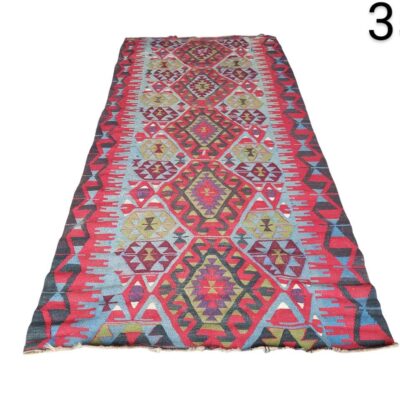 Vintage Turkish Kilim rug with geometric patterns in red and blue tones for rent for events, advertising, films and series.