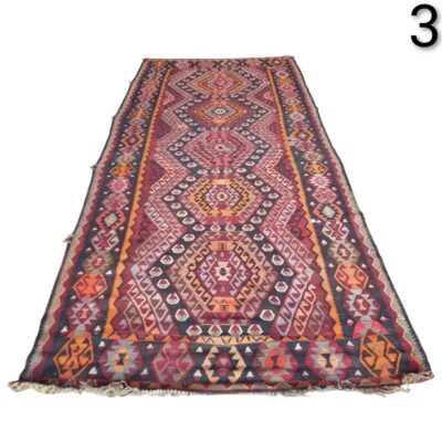 Vintage Turkish kilim style handwoven wool hallway rug, characterised by vibrant geometric patterns in shades of purple, pink and orange, for rent for events, advertising, films and series.