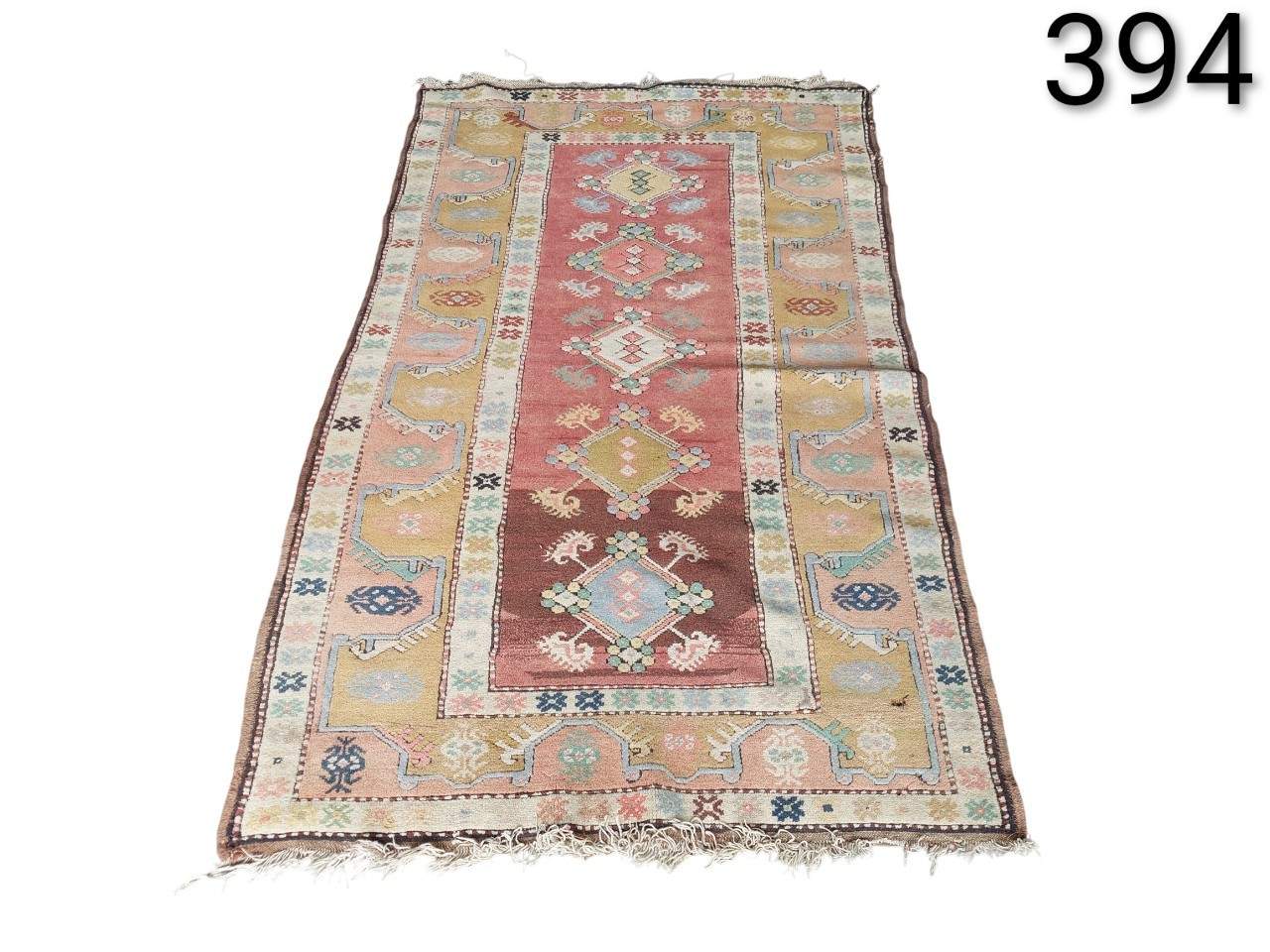 Turkish vintage kilim wool rug with geometric motifs and pastel tones for rent for events, advertising, films and series.