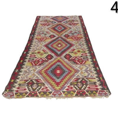 Handmade vintage turkish Kilim rug with geometric patterns in red, blue and green tones for rent for events, advertising, films and series.
