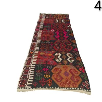 Turkish vintage kilim handwoven wool rug with tribal geometric patterns in red and black tones for rent for events, advertising, films and series.