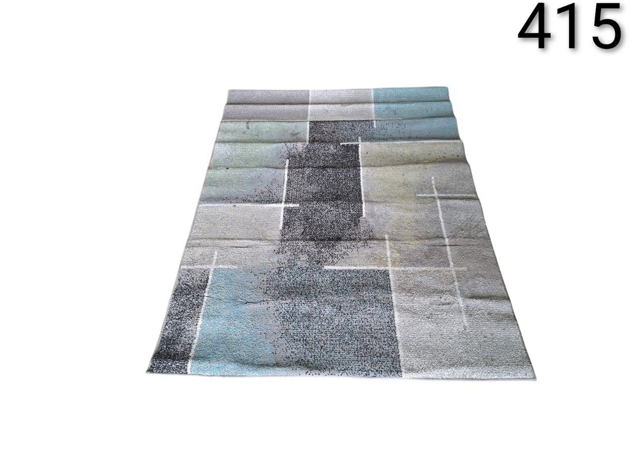 Paco Home modern rug with geometric squares design in grey and turquoise tones for rent for events, advertising, films and series.
