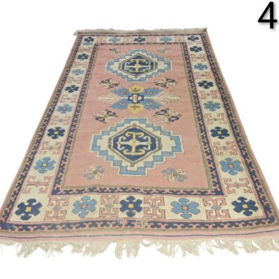 Handmade vintage turkish pink wool rug with blue geometric patterns for rent for events, advertising, film and series.