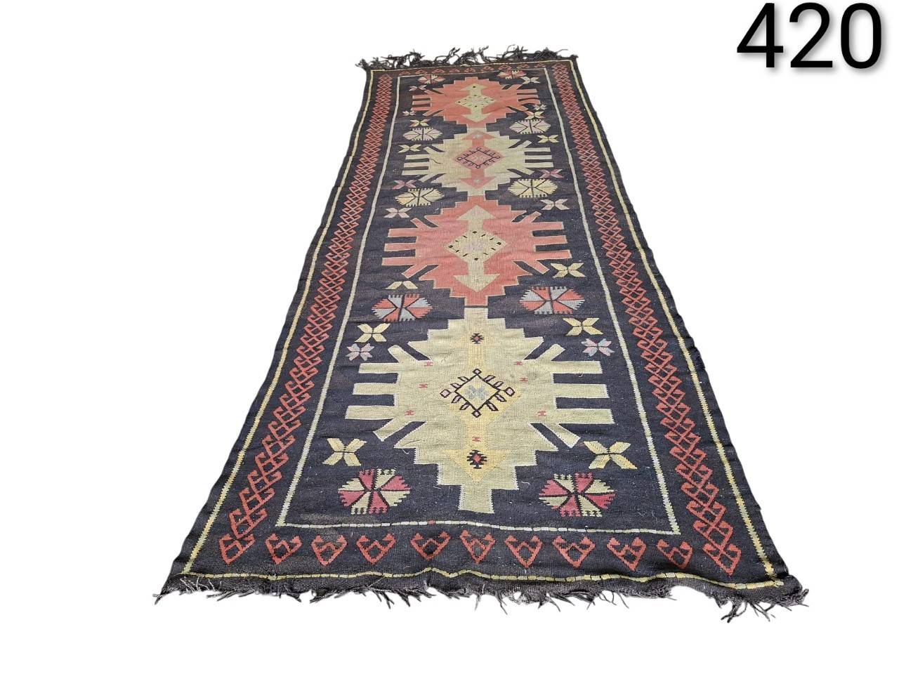 Turkish vintage kilim handmade wool rug, characterised by its flat weave and geometric motifs, for rent for events, advertising, films and series.