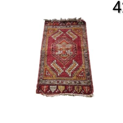 Vintage Turkish hand knotted wool rug with a red geometric design for rent for events, advertising, films and series.