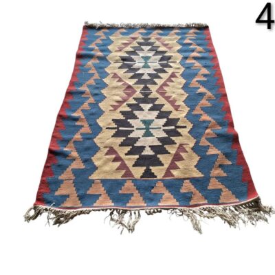 A vintage Persian or Afghan tribal style rug, hand woven with traditional Kilim techniques, for rent for events, advertising, films and series.