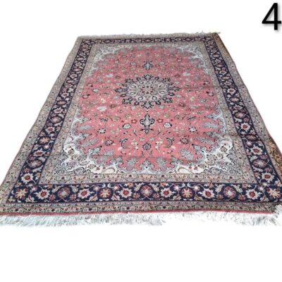 Hand knotted Persian Tabriz rug with a central medallion on a pink background and navy blue border for rent for events, advertising, films and series.
