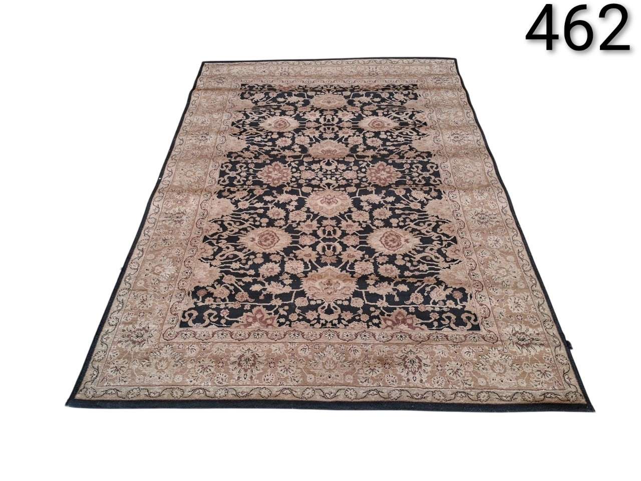 Hand knotted Sadraa design carpet with oriental floral patterns in black and beige tones for rent for events, advertising, films and series.