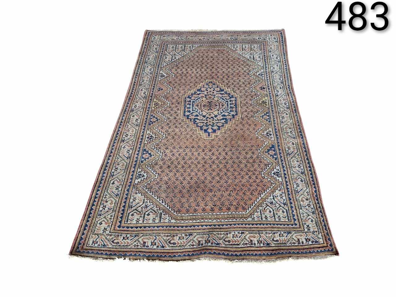 Hand-knotted Persian rug, possibly Bidjar style or similar, characterised by a central blue medallion on a light background and detailed geometric motifs, for rent for events, advertising, films and series.