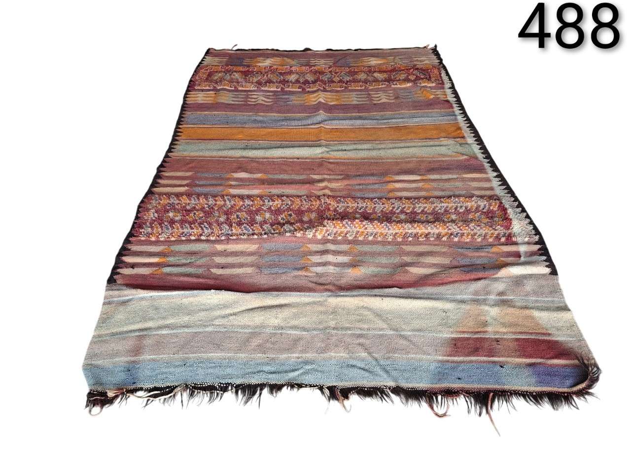 Vintage hand-woven wool Kilim rug with a geometric striped pattern for rent for events, advertising, films and series.