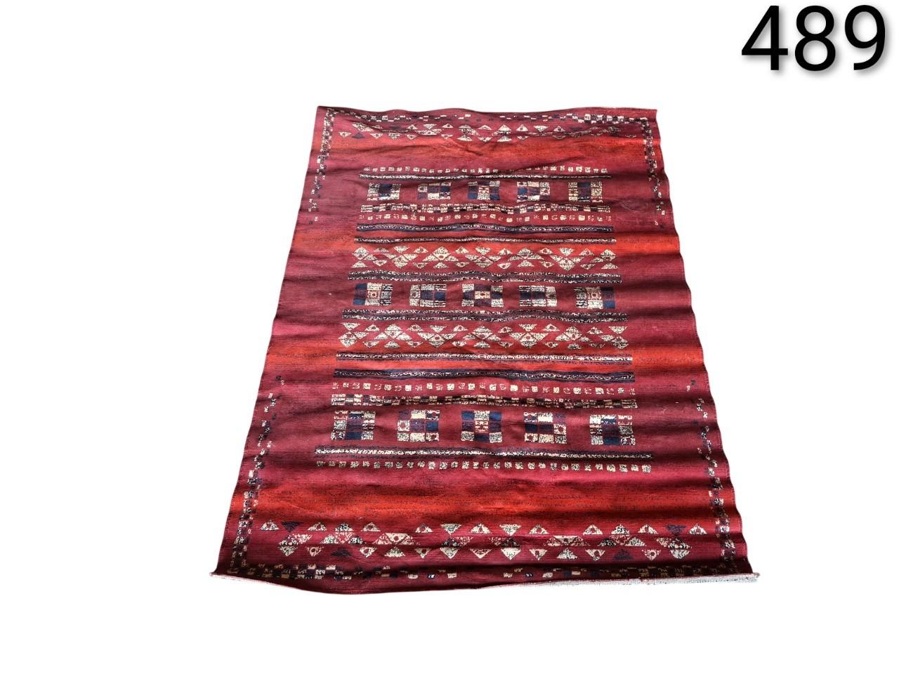 Moroccan red wool Kilim rug with tribal geometric patterns for rent for events, advertising, movies and series.