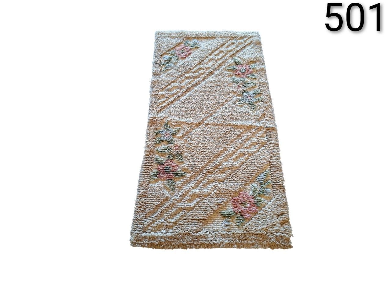Handmade wool rug with floral design in pink and green tones on a beige background for rent for events, advertising, films and series.
