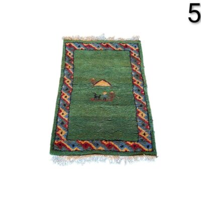 Handmade Gabbeh rug with geometric design and nomadic motifs in shades of greenfor rent for events, advertising, films and series.