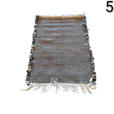 Cotton carpet with fringes and reversible geometric print of black and white rhombuses for rent for events, advertising, films and series.