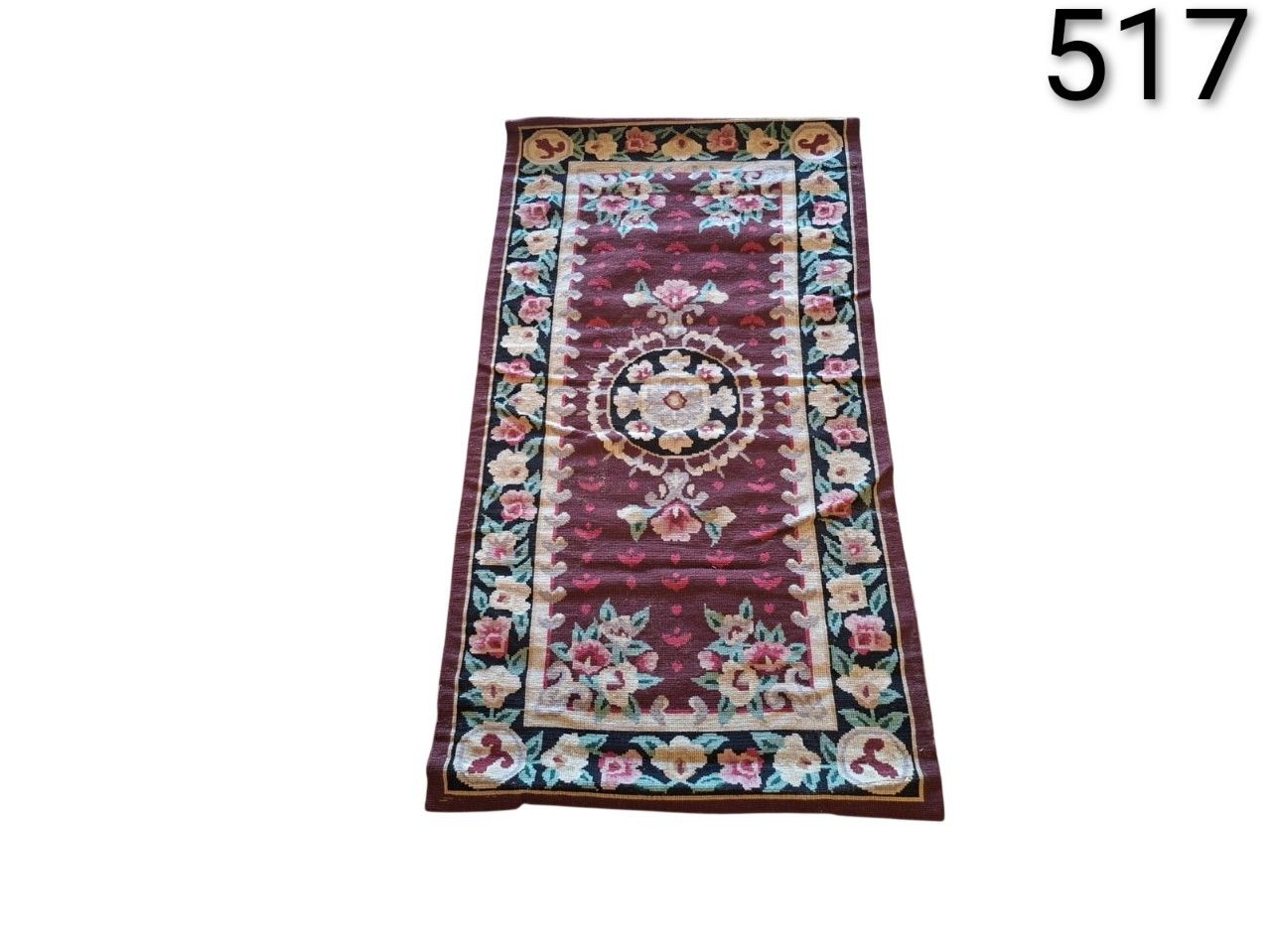 Vintage flat weave Kilim rug, probably of Turkish or Bessarabian origin, featuring intricate floral designs on a dark brown background, rented for events, advertising, films and series.