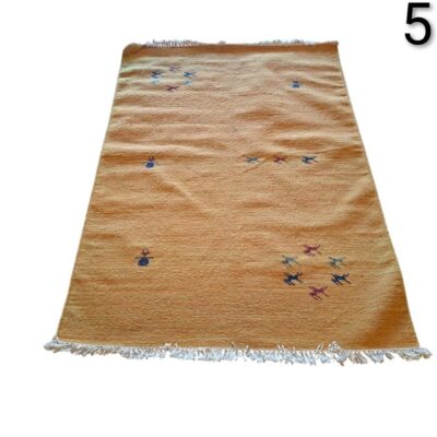 Gabbeh type wool rug, with a simple tribal design and vibrant colours for rent for events, advertising, films and series.