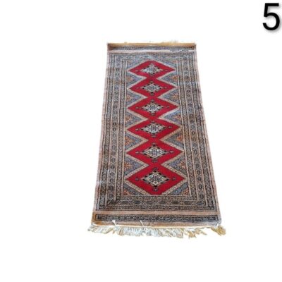 Traditional hand knotted oriental rug with a geometric design for rent for events, advertising, films and series.