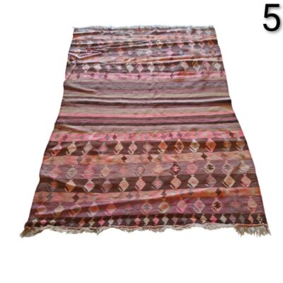 Handmade vintage turkish kilim rug with geometric patterns in brown and pink tones for rent for events, advertising, movies and series.