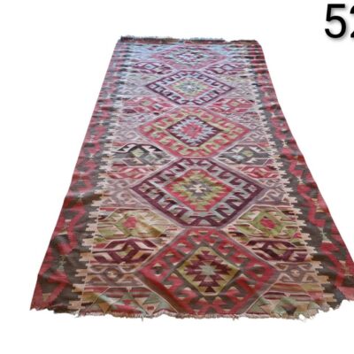 Turkish Kilim rug with geometric hand-woven design in red, green and purple tones for rent for events, advertising, films and series.