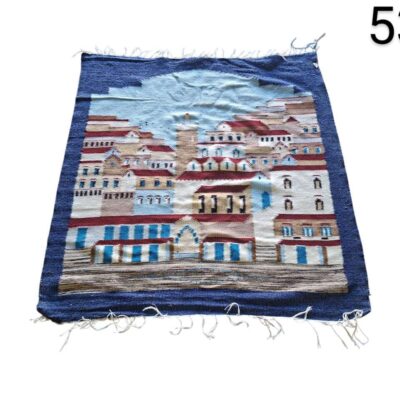 Hand-woven carpet featuring a coastal scene with white buildings for rent for events, advertising, films and series.