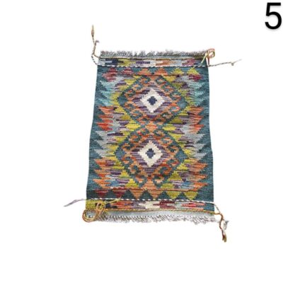 Handmade Afghan Kilim rug with a geometric diamond pattern in shades of teal, orange and multicolour for rent for events, advertising, films and series.