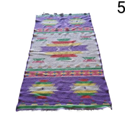 Hand-woven kilim carpet with multicoloured geometric patterns for rent for events, advertising, films and series.