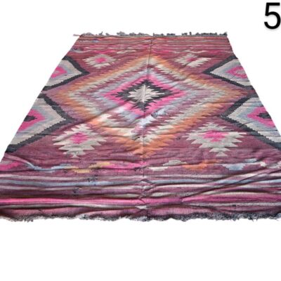 Vintage turkish handmade Kilim rug with wool and vegetable dyes in pink, purple and brown tones for rent for events, advertising, films and series.