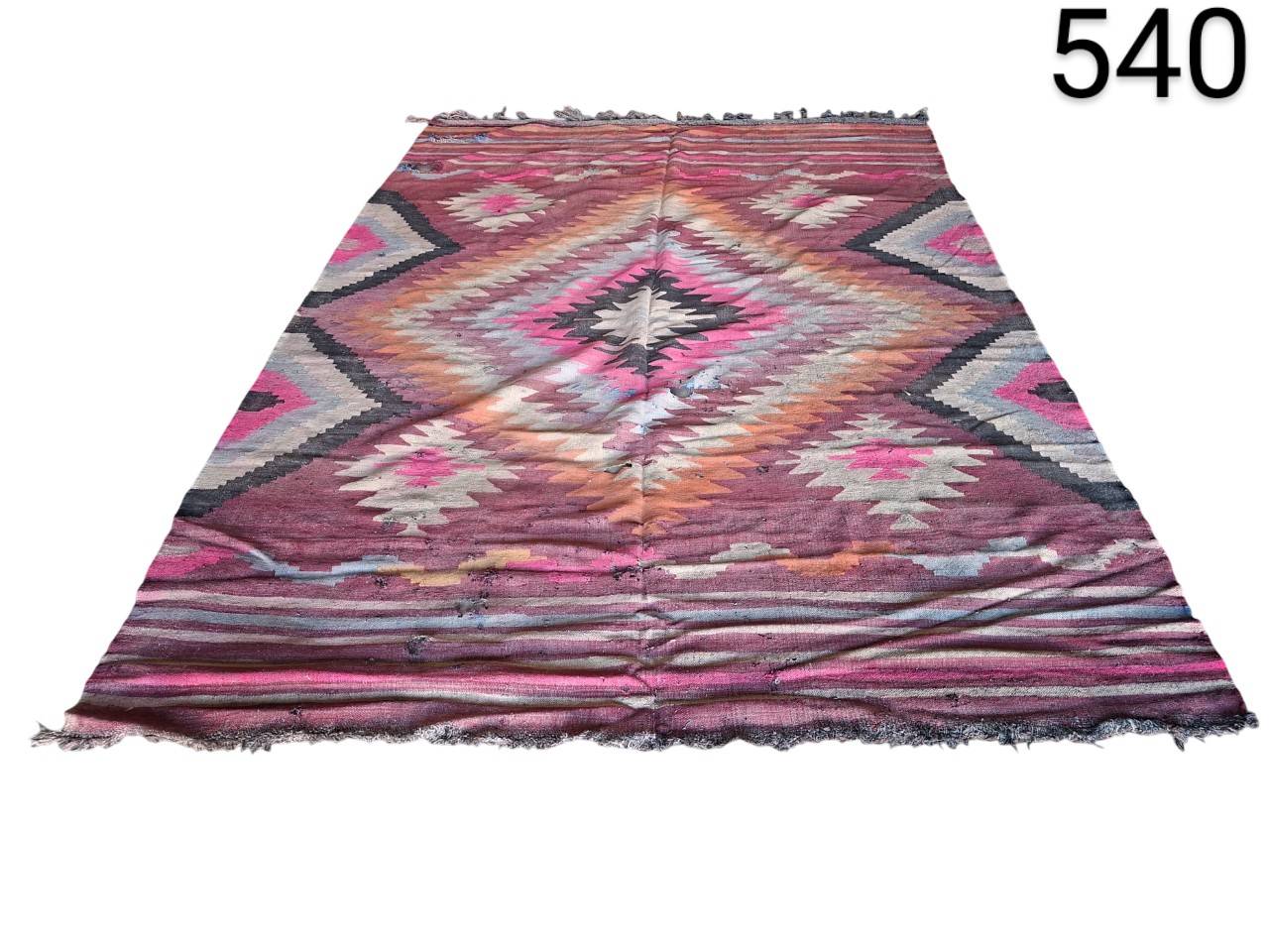 Vintage turkish handmade Kilim rug with wool and vegetable dyes in pink, purple and brown tones for rent for events, advertising, films and series.