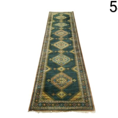 Hallway carpet features a geometric design in oriental style with petrol blue colours and details in beige and brown tones for rent for events, advertising, films and series.