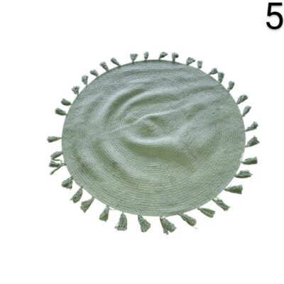 Round green cotton rug with pompoms on the edges by Maisons du Monde for rent for events, advertising, films and series.