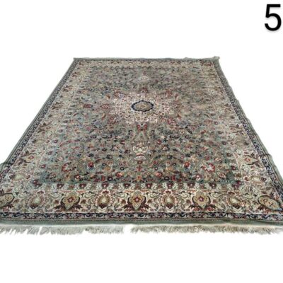 Traditional Persian style rug with an intricate floral design and a central medallion in shades of blue, green and burgundy for rent for events, advertising, films and series.