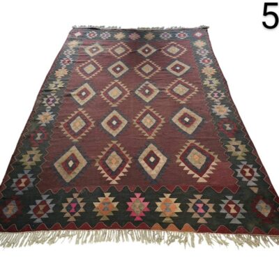 Handmade vintage turkish Kilim rug with geometric patterns in red and brown tones for rent for events, advertising, movies and series.
