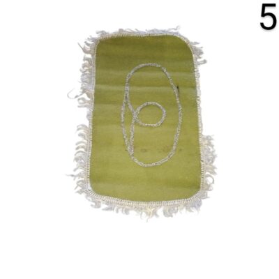 Rectangular green prayer rug or decorative mat with frayed edges and an embroidered design in the centre for rent for events, advertising, films and series.