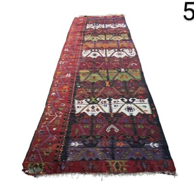 Vintage Turkish Kilim wool corridor carpet with tribal geometric motifs in red and black tones for rent for events, advertising, films and series.