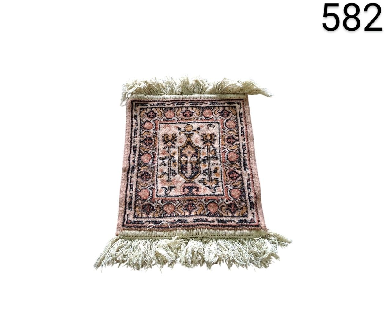 Hand knotted cashmere rug with an intricate floral design in peach and beige tones for rent for events, advertising, films and series.