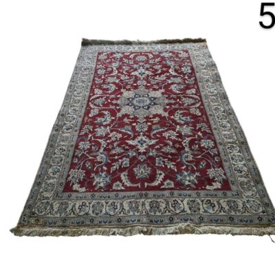 Hand knotted Persian Nain rug with a central medallion on a red background for rent for events, advertising, films and series.