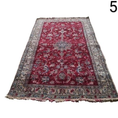Red oriental carpet with a detailed floral design for rent for events, advertising, films and series.