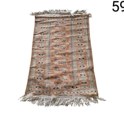 Traditional Persian or Turkish style carpet in shades of orange and brown, with intricate geometric patterns and white fringes for rent for events, advertising, films and series.