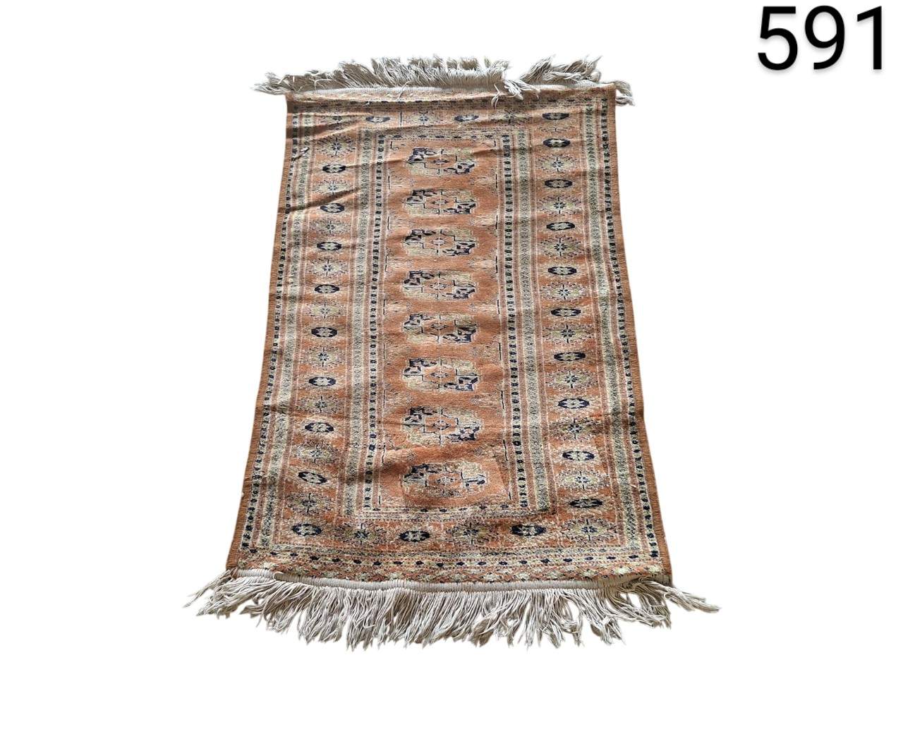 Traditional Persian or Turkish style carpet in shades of orange and brown, with intricate geometric patterns and white fringes for rent for events, advertising, films and series.