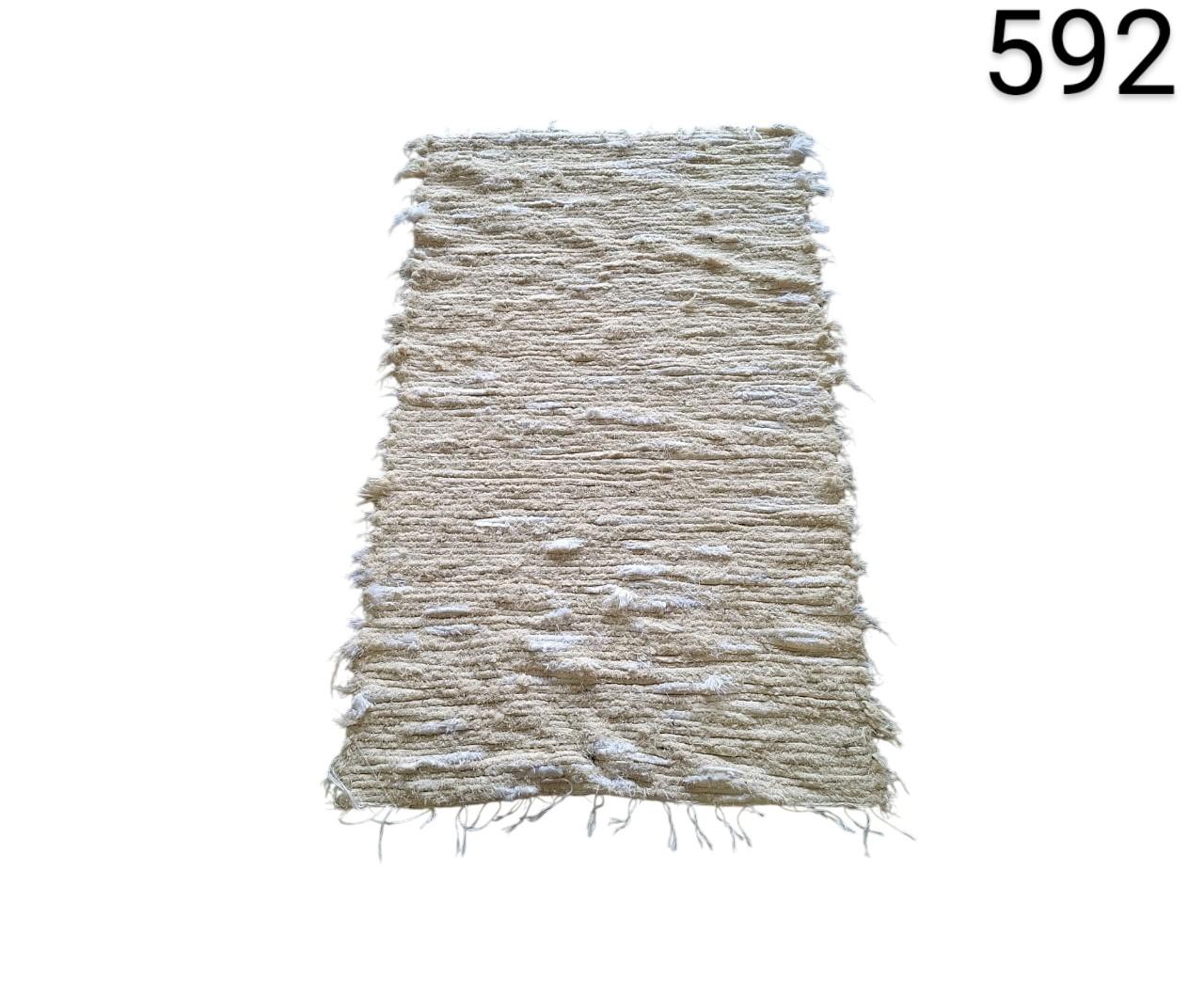 Beige coloured, cotton woven rug with fringes at the ends, for rent for events, advertising, films and series.