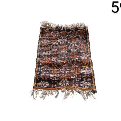 Small woollen carpet with tribal geometric design, possibly of Moroccan or Afghan origin, for rent for events, advertising, films and series.