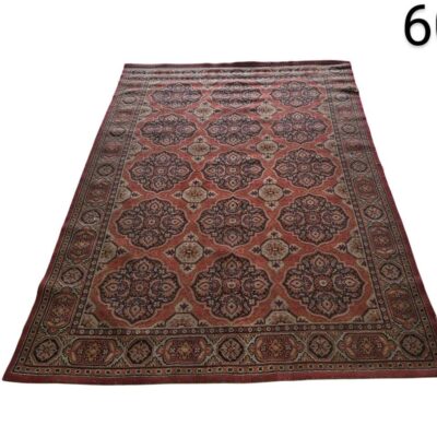 Beljik style carpet features tribal geometric patterns in terracotta, beige and navy blue tones for rent for events, advertising, films and series.