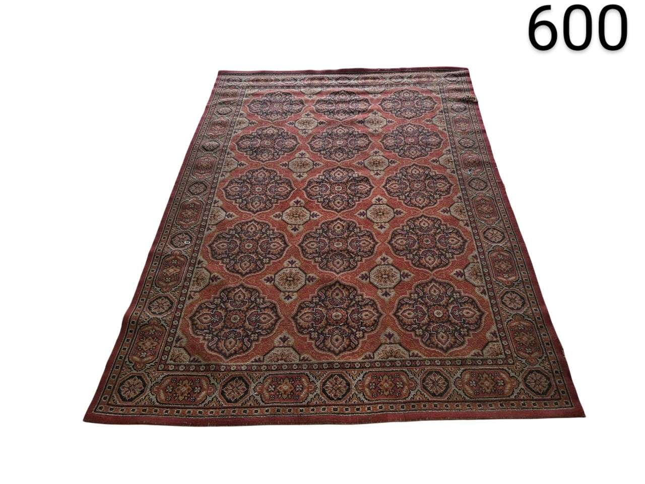 Beljik style carpet features tribal geometric patterns in terracotta, beige and navy blue tones for rent for events, advertising, films and series.