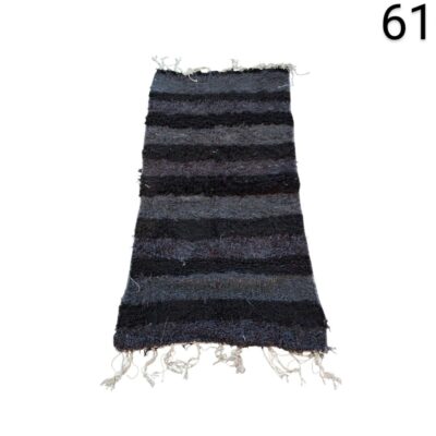 Handmade black and grey carpet with fringes for rent for events, advertising, films and series.
